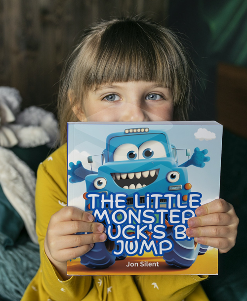 girl holding the little monster truck book